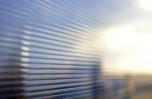 Blue surface of striped polycarbonate with a reflection of the blue distance of the city